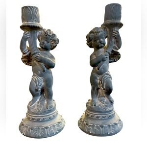 A pair of cherub candle holders by, Omamental Arts, Inc.